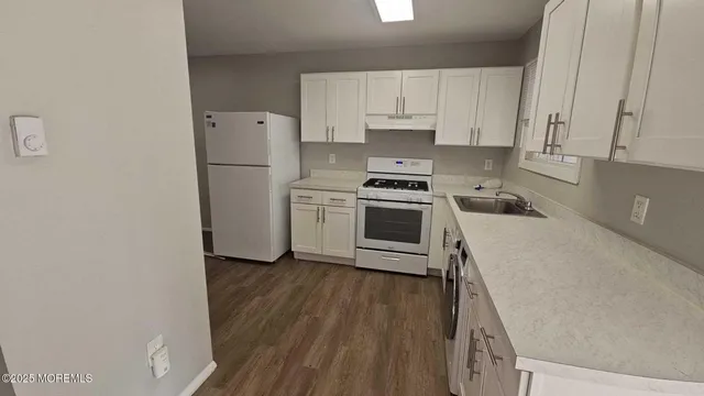 a kitchen with a white cabinets and white appliances