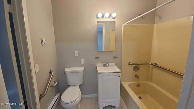 a bathroom with a toilet sink and shower