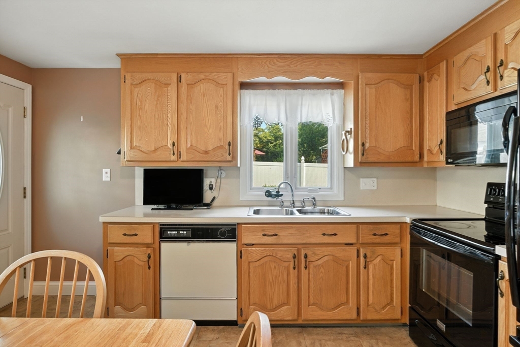 77 Bowers Street West Springfield, MA 01089 - Photo 11 of 36 a kitchen with stainless steel appliances granite countertop a stove a sink and a microwave