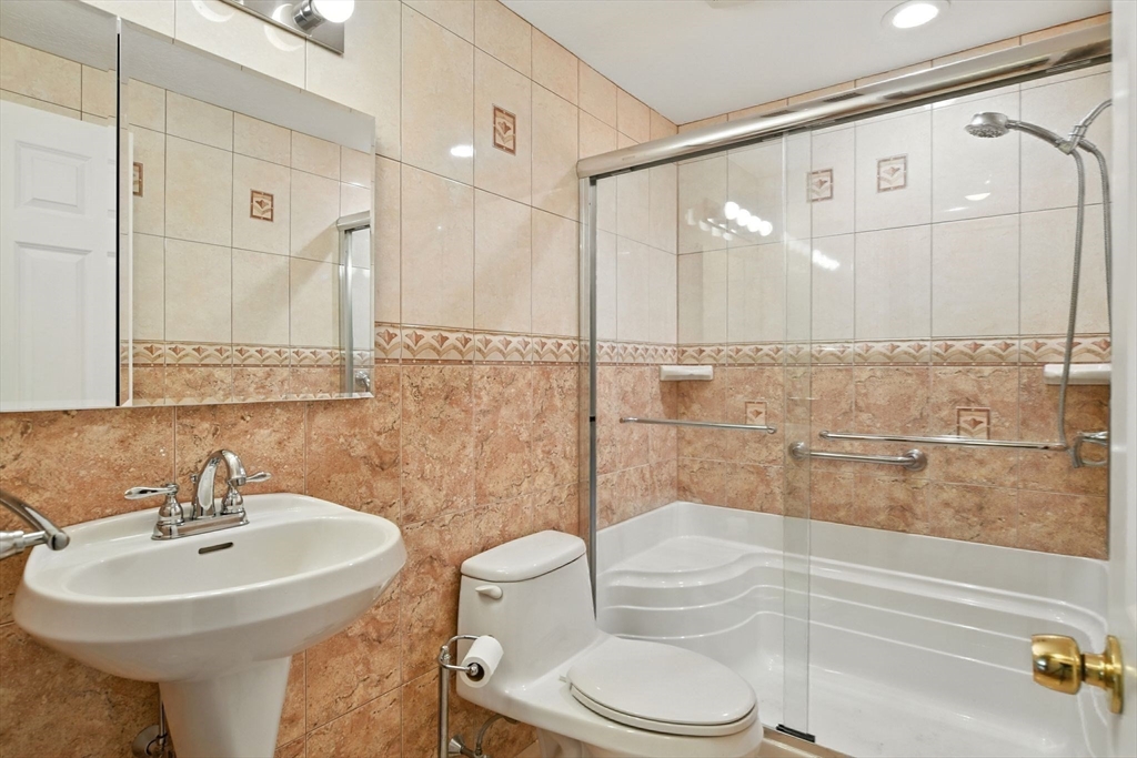 77 Bowers Street West Springfield, MA 01089 - Photo 16 of 36 a bathroom with a sink toilet and shower