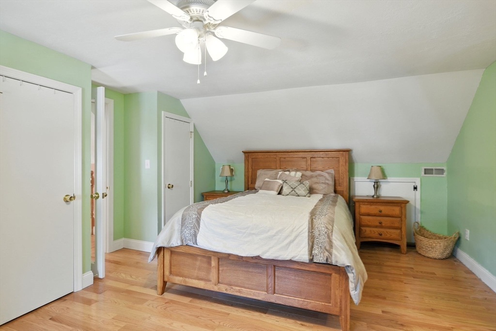 77 Bowers Street West Springfield, MA 01089 - Photo 22 of 36 a bedroom with a bed and a chandelier