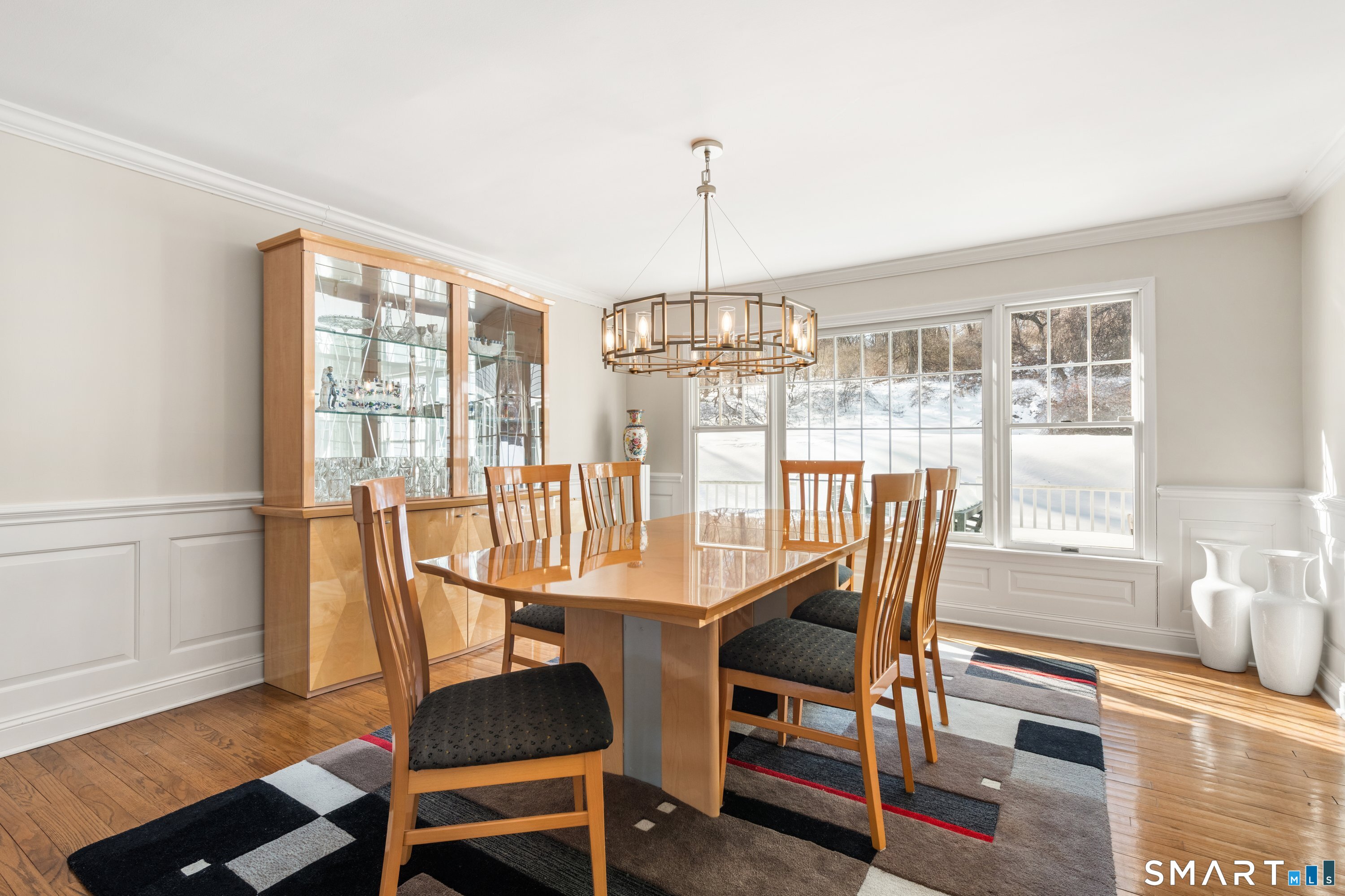 309 Sturges Ridge Road Wilton, CT 06897 - Photo 11 of 33 a dining room with furniture a chandelier and wooden floor