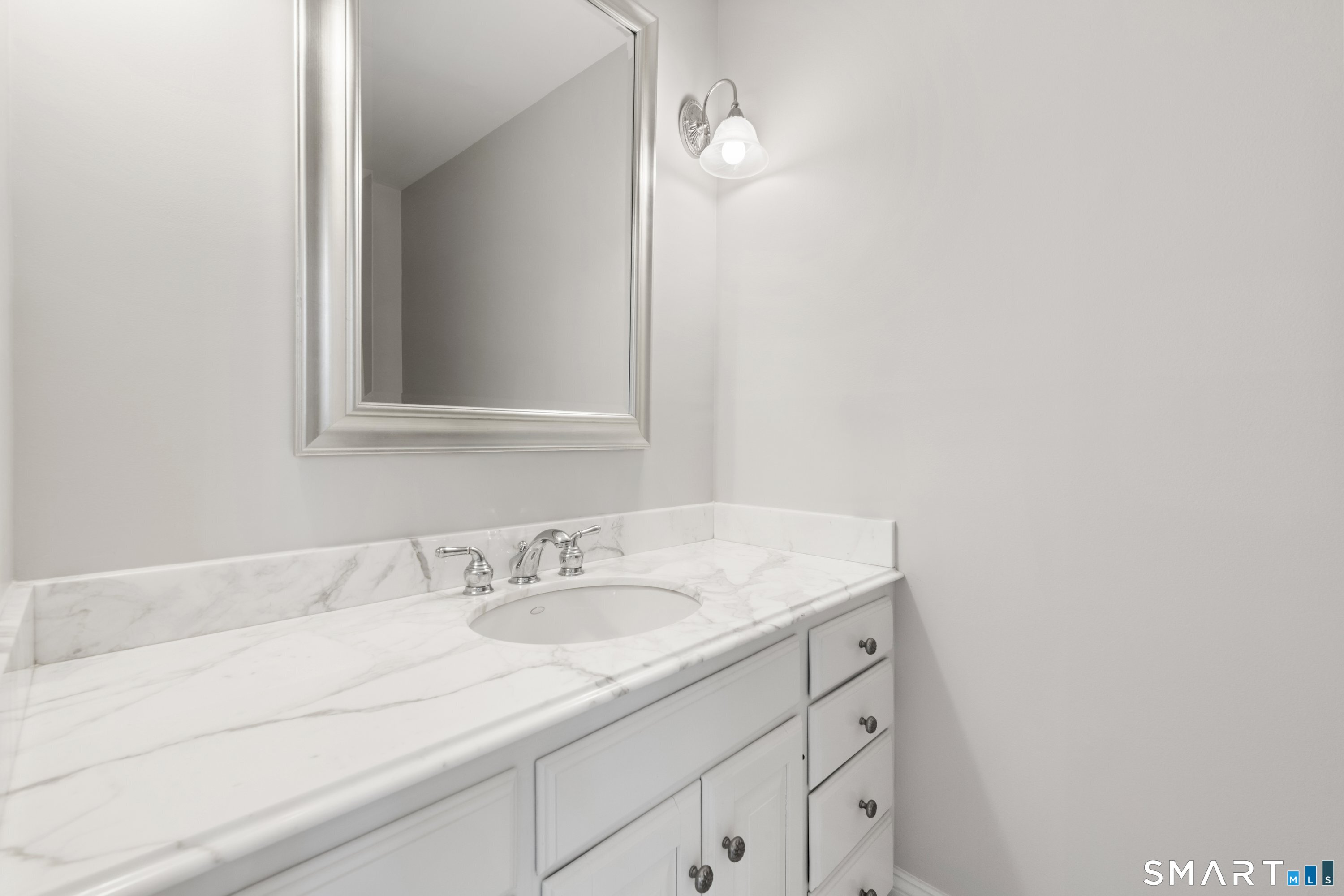 309 Sturges Ridge Road Wilton, CT 06897 - Photo 16 of 33 a bathroom with a sink and a mirror