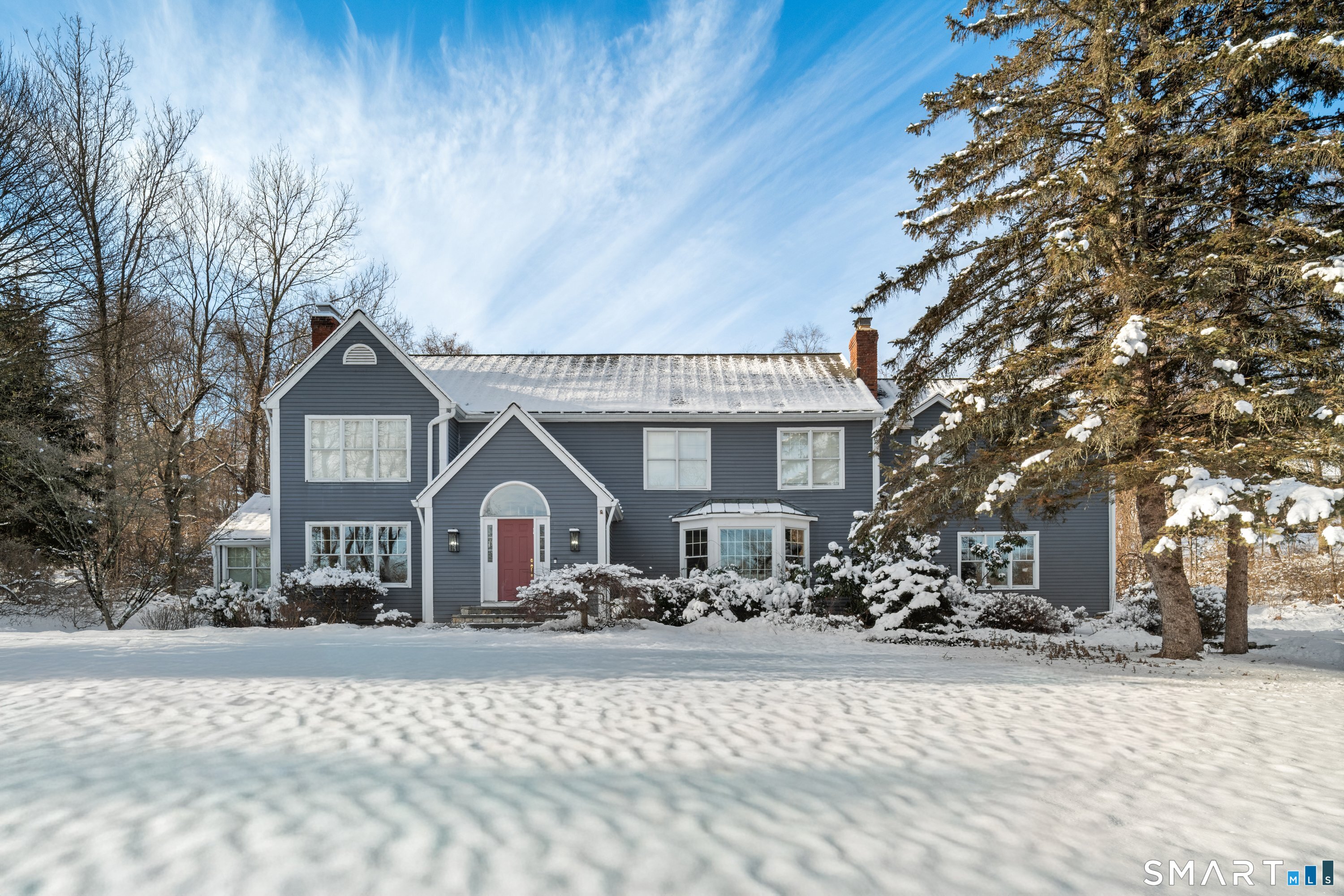 309 Sturges Ridge Road Wilton, CT 06897 - Photo 22 of 33 a front view of a house with a yard covered in snow