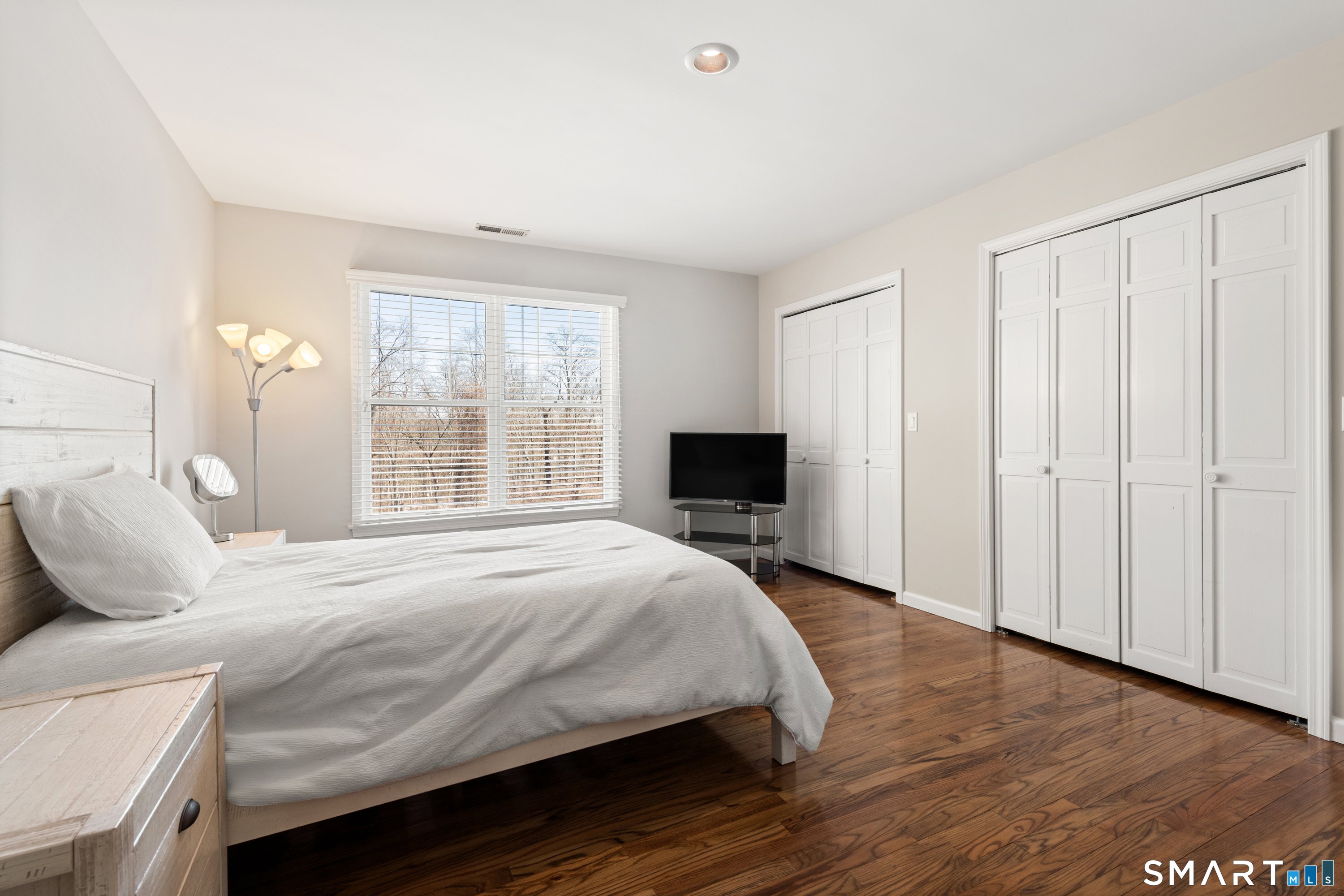 309 Sturges Ridge Road Wilton, CT 06897 - Photo 30 of 33 a bedroom with a bed and wooden floor