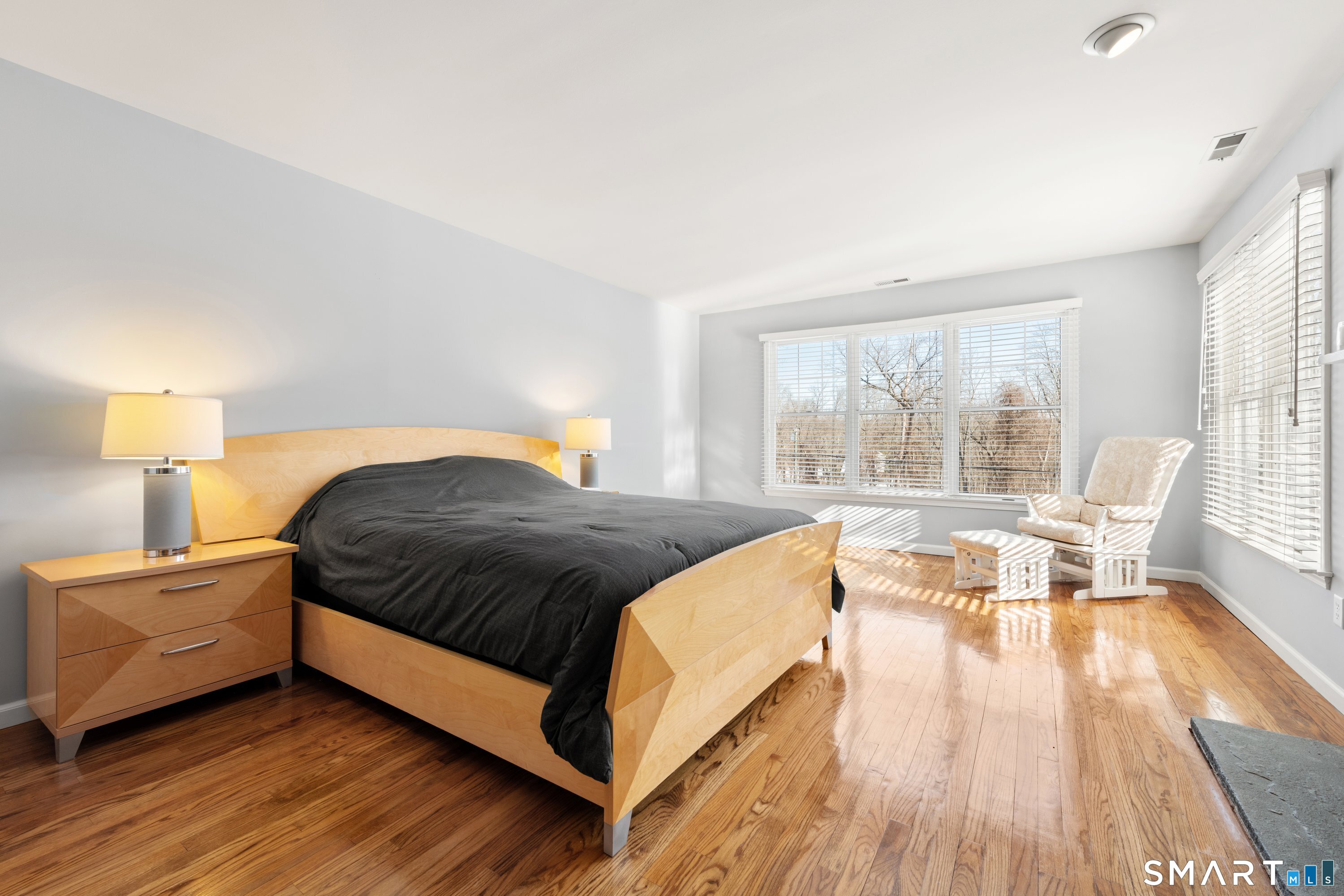 309 Sturges Ridge Road Wilton, CT 06897 - Photo 33 of 33 a spacious bedroom with a bed and wooden floor