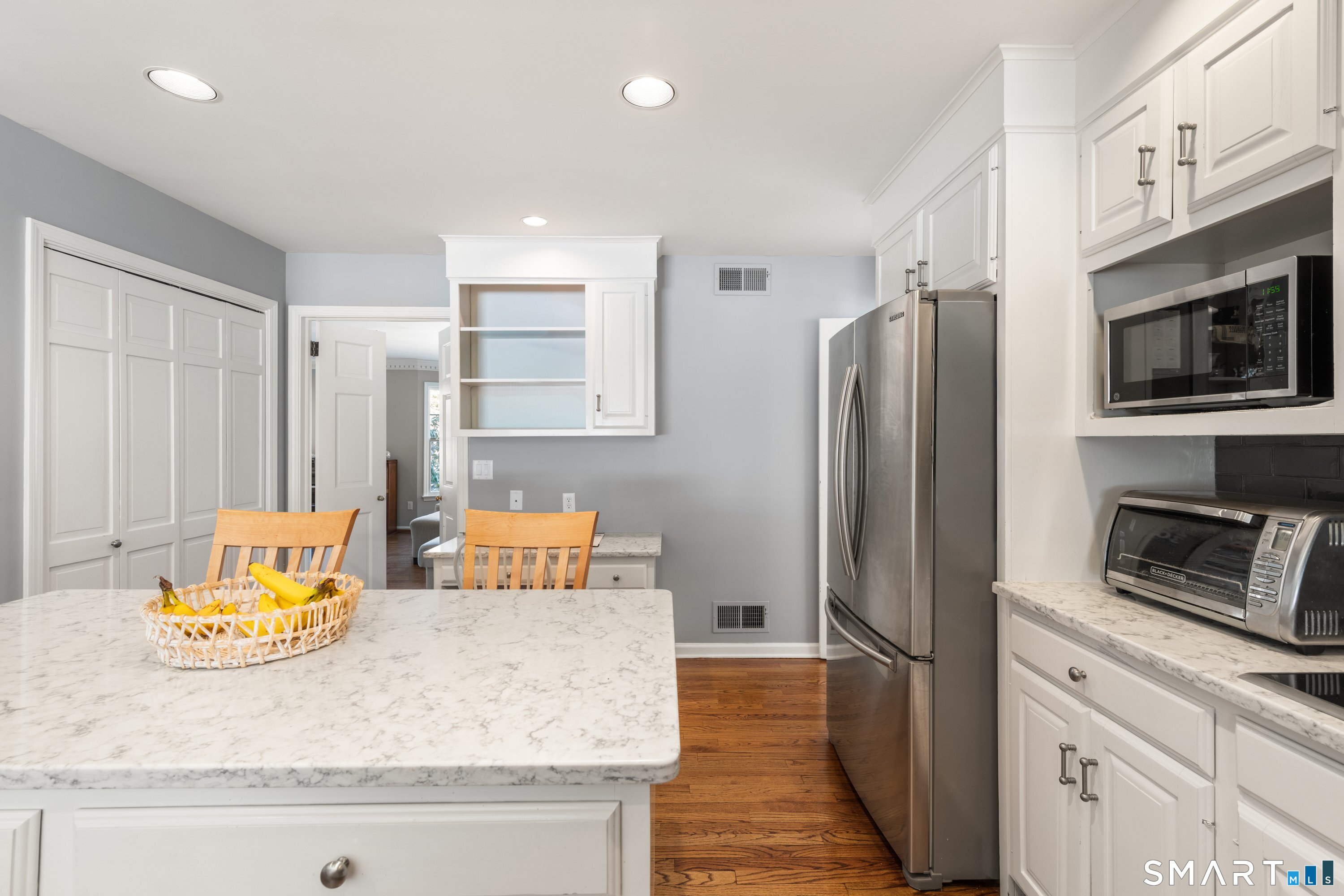 309 Sturges Ridge Road Wilton, CT 06897 - Photo 4 of 33 a kitchen with stainless steel appliances granite countertop a refrigerator a stove and a sink with wooden floor
