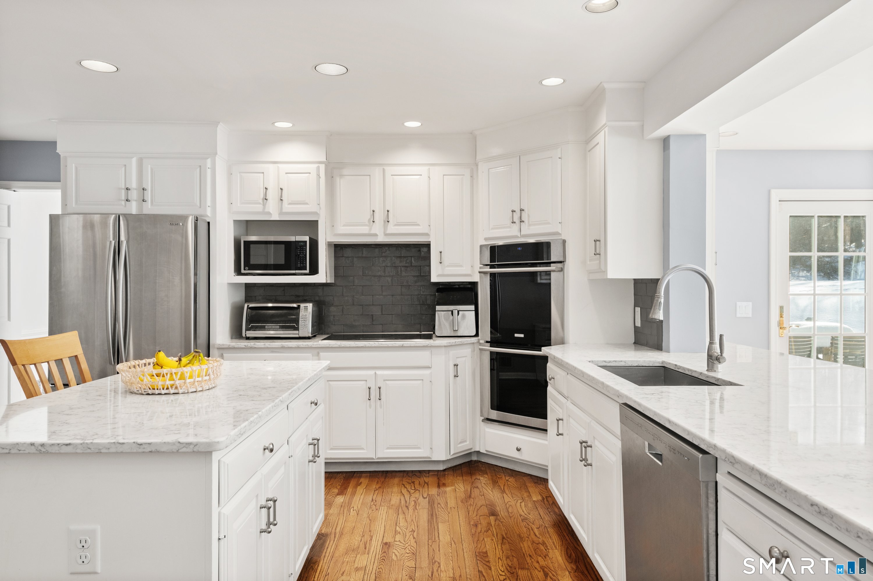 309 Sturges Ridge Road Wilton, CT 06897 - Photo 7 of 33 a kitchen with stainless steel appliances a stove refrigerator sink and microwave