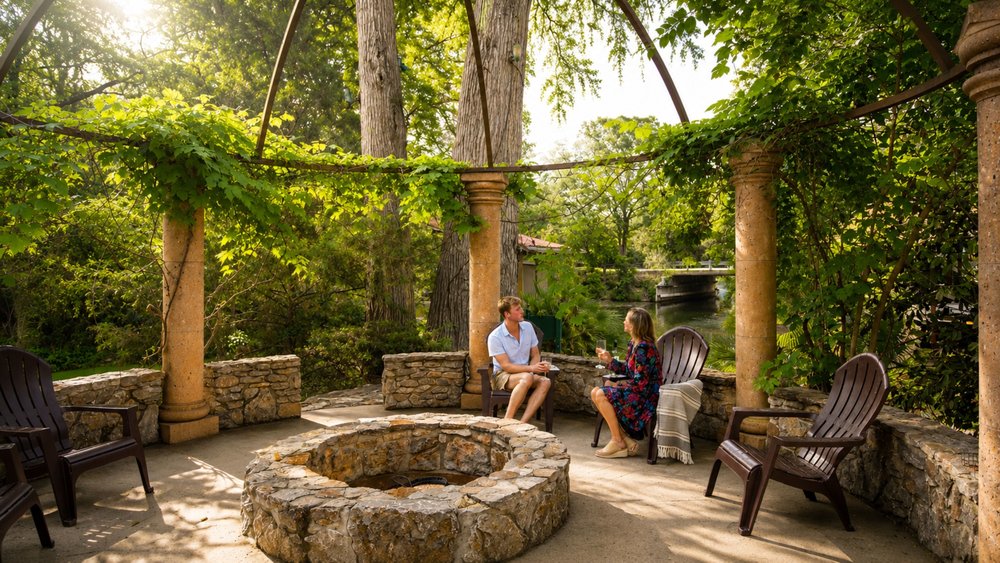 1815 Rue De St Tropez Austin, TX 78746 - Photo 7 of 40 Stone patio with an integrated fire pit, surrounded by lush foliage and mature trees