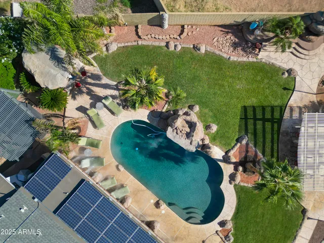 a front view of a house with a yard and potted plants