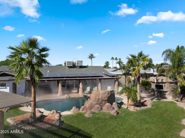 an aerial view of a house with a yard