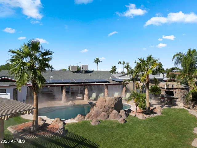 an aerial view of a house with a yard