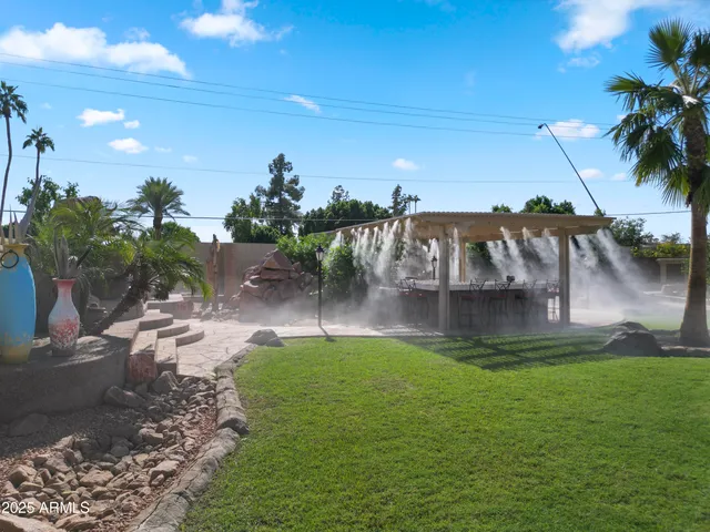 a view of a patio with table and chairs and potted plants