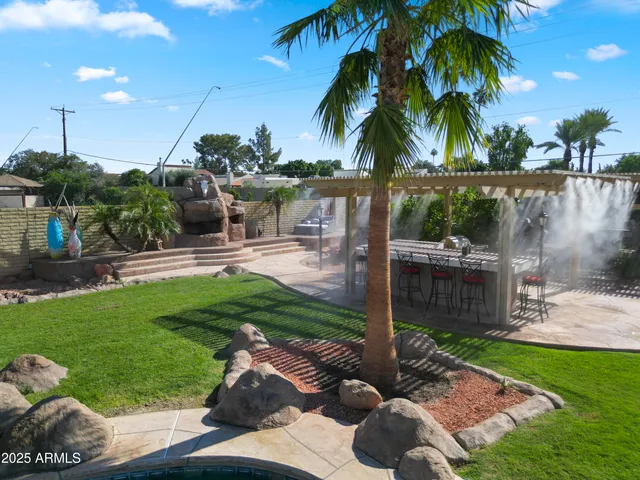 a front view of a house with a yard and potted plants