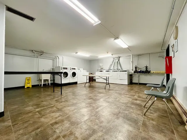 a room with lots of furniture and white walls