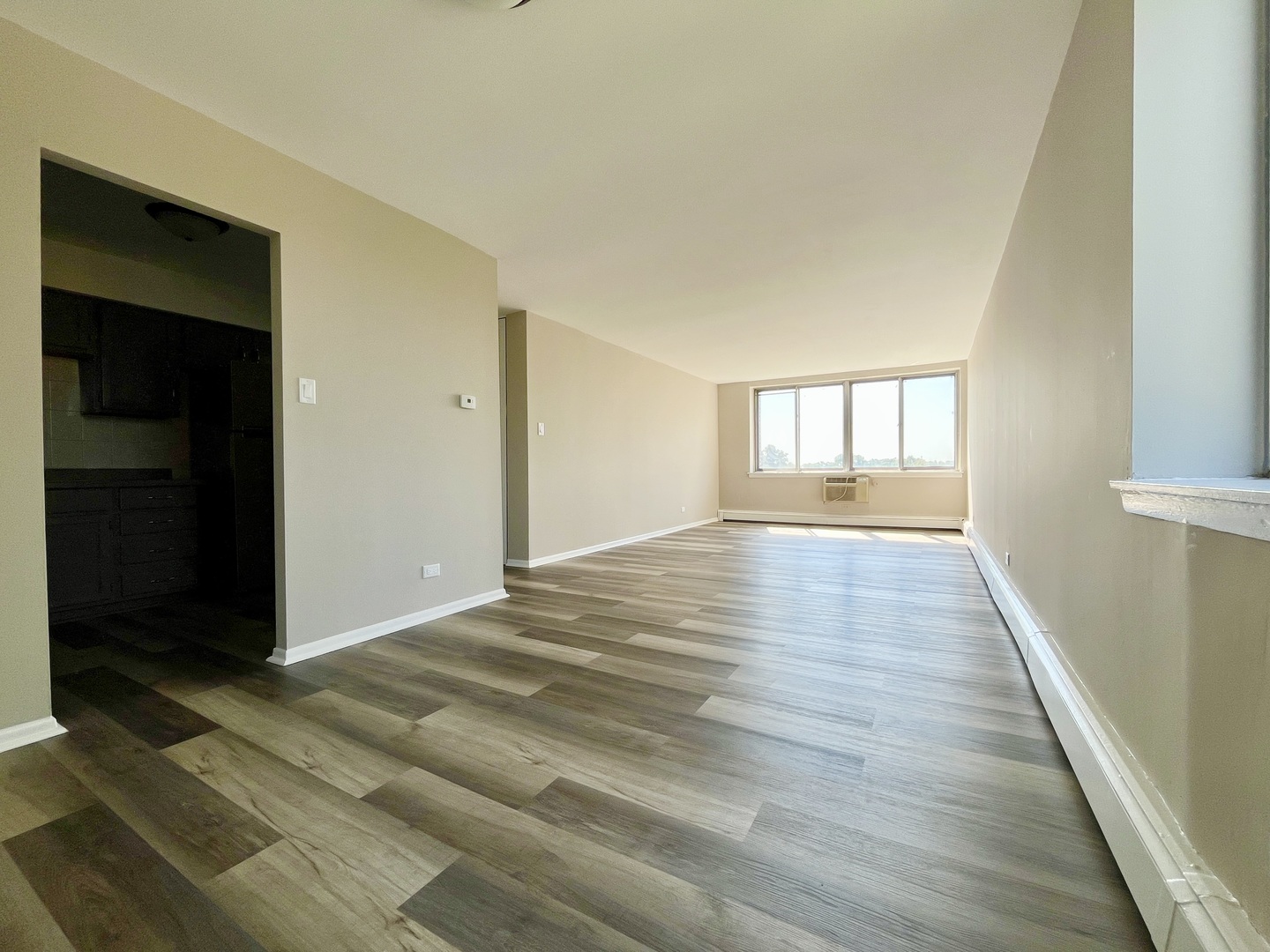9725 Karlov Avenue, Unit 501 Oak Lawn, IL 60453 - Photo 4 of 17 an empty room with wooden floor and windows
