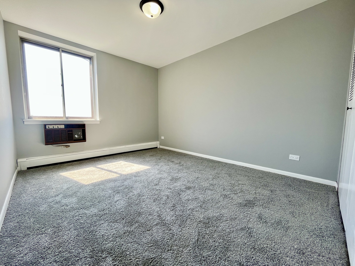 9725 Karlov Avenue, Unit 501 Oak Lawn, IL 60453 - Photo 7 of 17 an empty room with a fireplace and windows