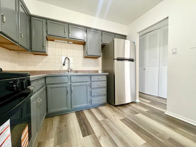 a kitchen with stainless steel appliances granite countertop a refrigerator sink and cabinets