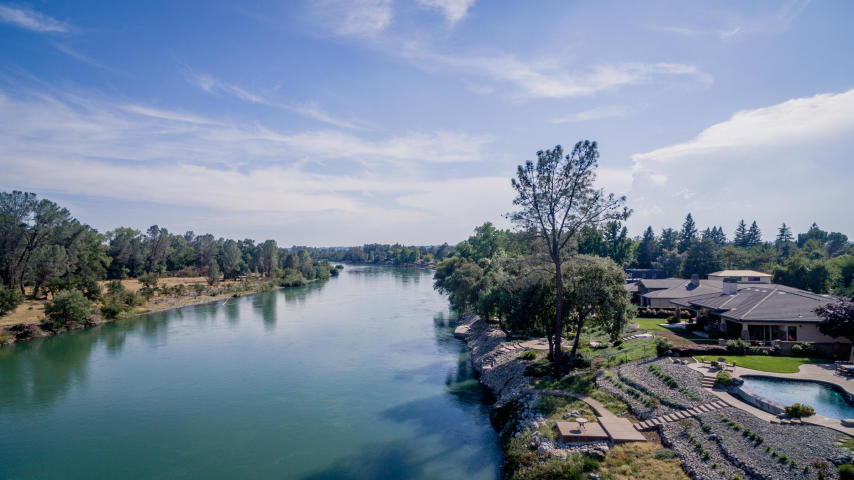 6039 Riverside Drive Redding, CA 96001 - Photo 3 of 10 a view of a lake with houses