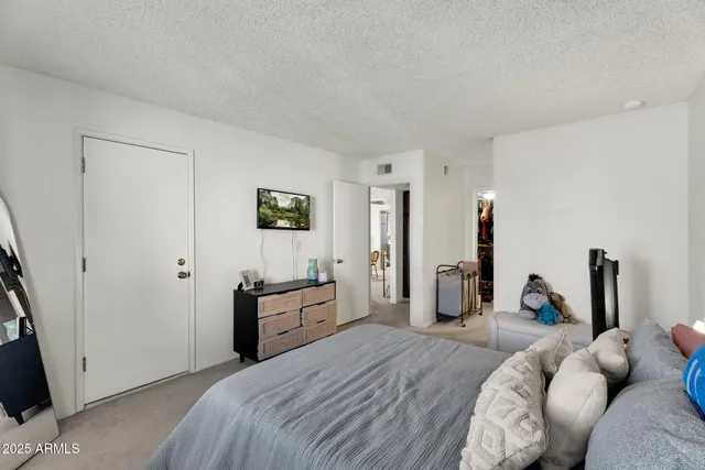 a bed room with a bed and dresser