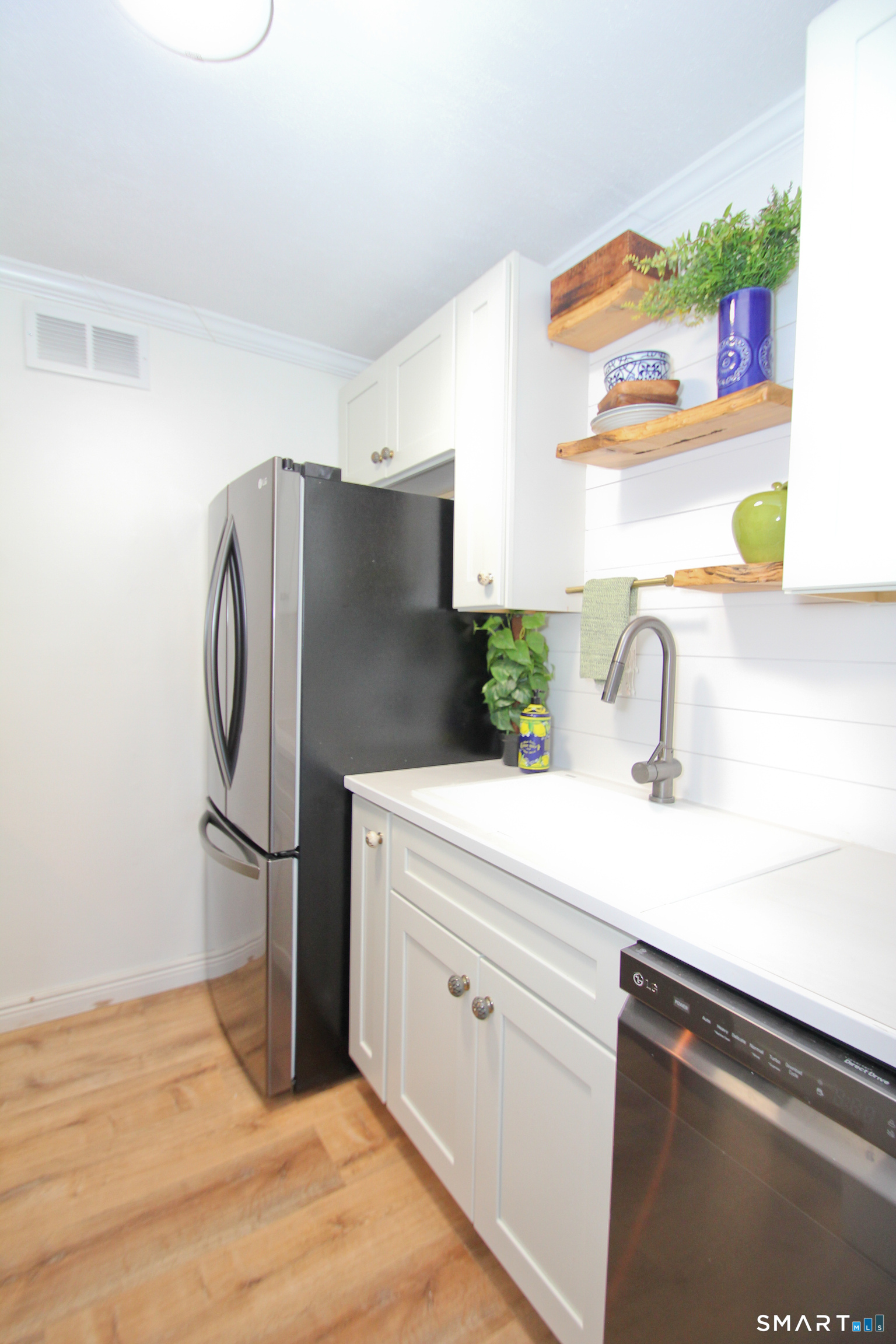a kitchen with a refrigerator and a sink