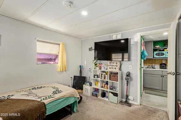 a bedroom with a bed and a flat screen tv