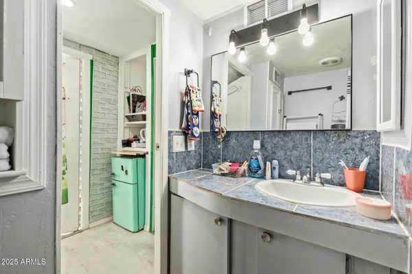 a bathroom with a sink double vanity and a mirror