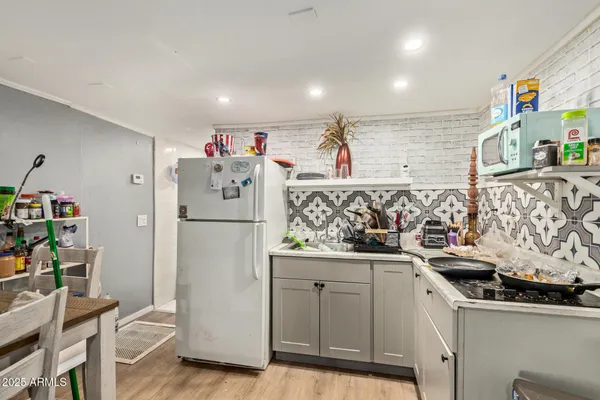 a kitchen with stainless steel appliances granite countertop a refrigerator and a sink