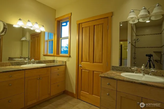a bathroom with a double vanity sink mirror and double
