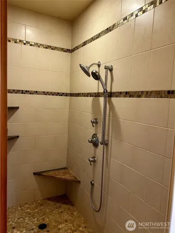 a bathroom with a window and a shower