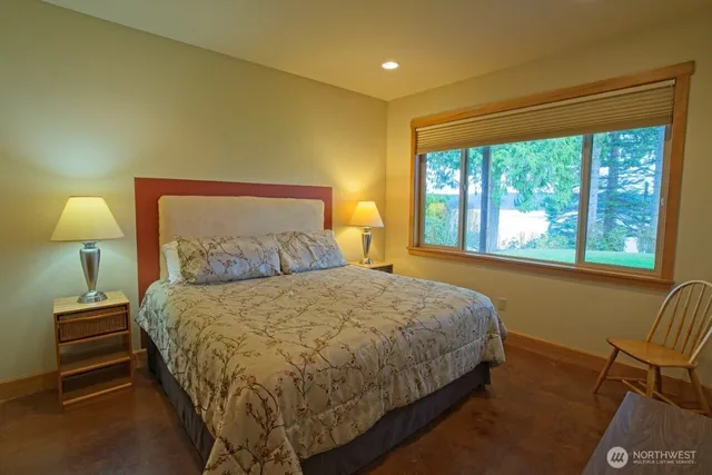 a bed sitting in a bedroom next to a window