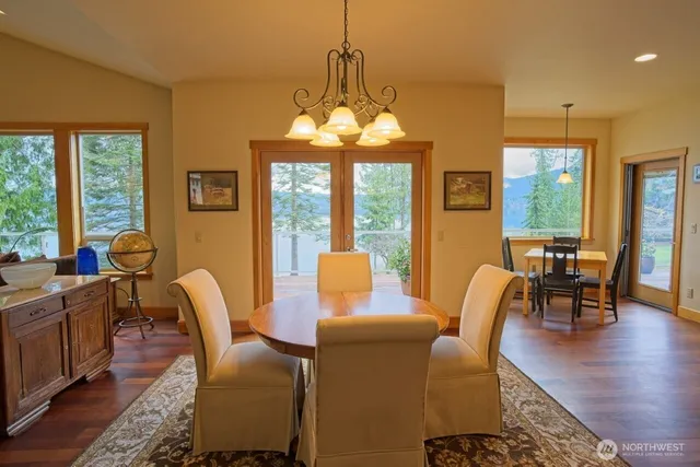 a dining room with furniture a chandelier and wooden floor