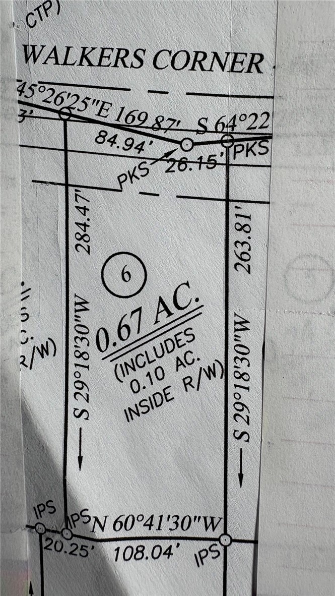 A detailed plat map outlines property dimensions and corner markers for a prime parcel.
