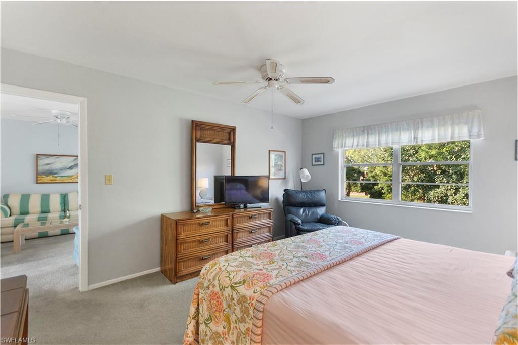 499 Forest Lakes Boulevard, Unit 2304 Naples, FL 34105 - Photo 15 of 21 a bedroom with a bed and furniture