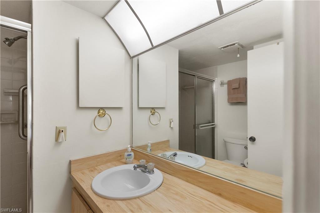499 Forest Lakes Boulevard, Unit 2304 Naples, FL 34105 - Photo 16 of 21 a bathroom with a sink and a mirror