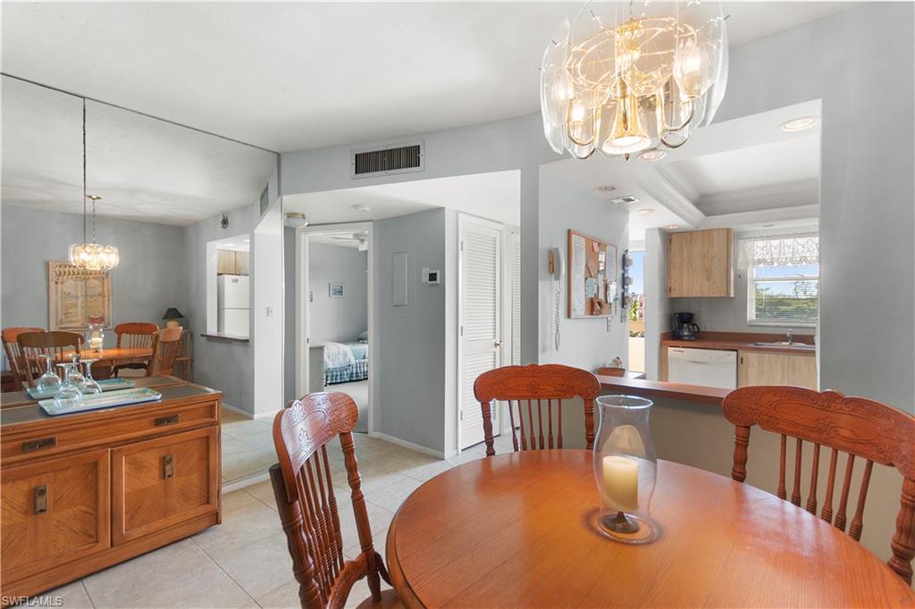 499 Forest Lakes Boulevard, Unit 2304 Naples, FL 34105 - Photo 4 of 21 a view of a dining room with furniture