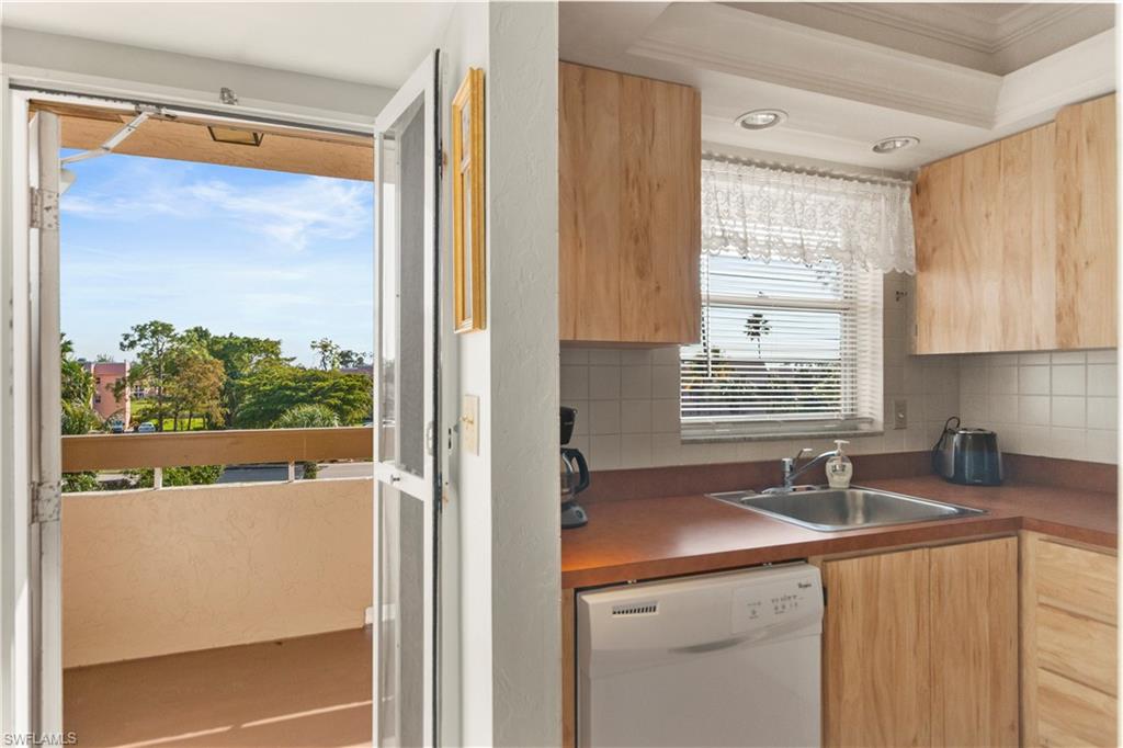 499 Forest Lakes Boulevard, Unit 2304 Naples, FL 34105 - Photo 5 of 21 a kitchen with a sink and a large window