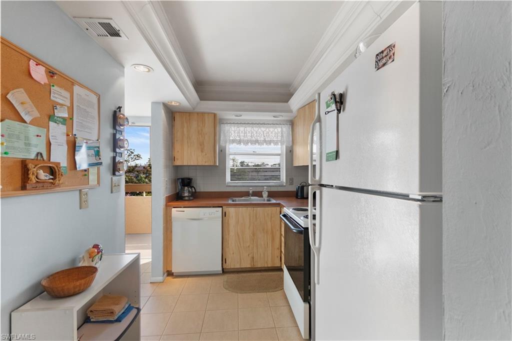 499 Forest Lakes Boulevard, Unit 2304 Naples, FL 34105 - Photo 10 of 21 a kitchen with stainless steel appliances granite countertop a refrigerator and a sink