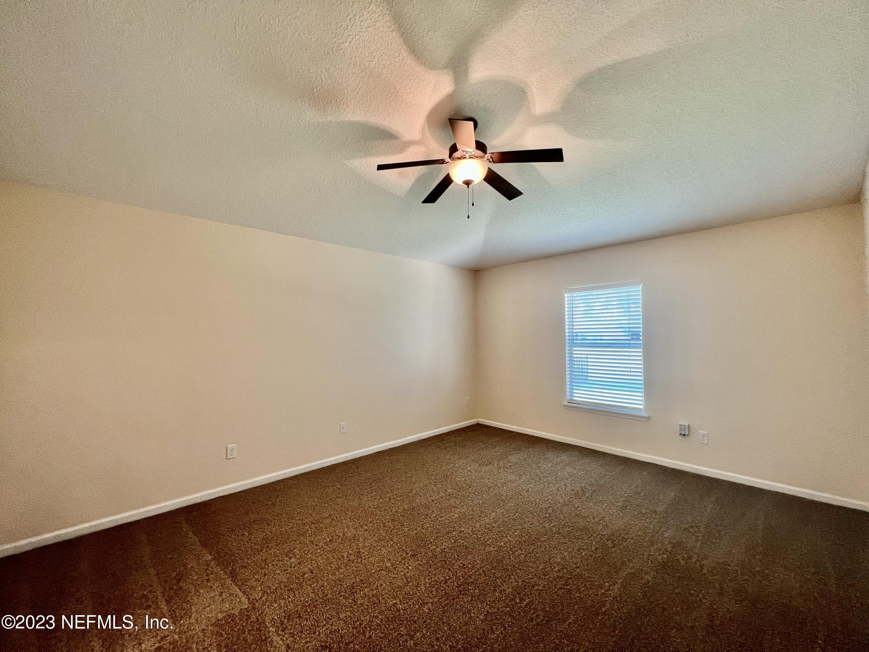 120 East Franchetta Lane St. Augustine, FL 32092 - Photo 12 of 25 an empty room with a window and a fan