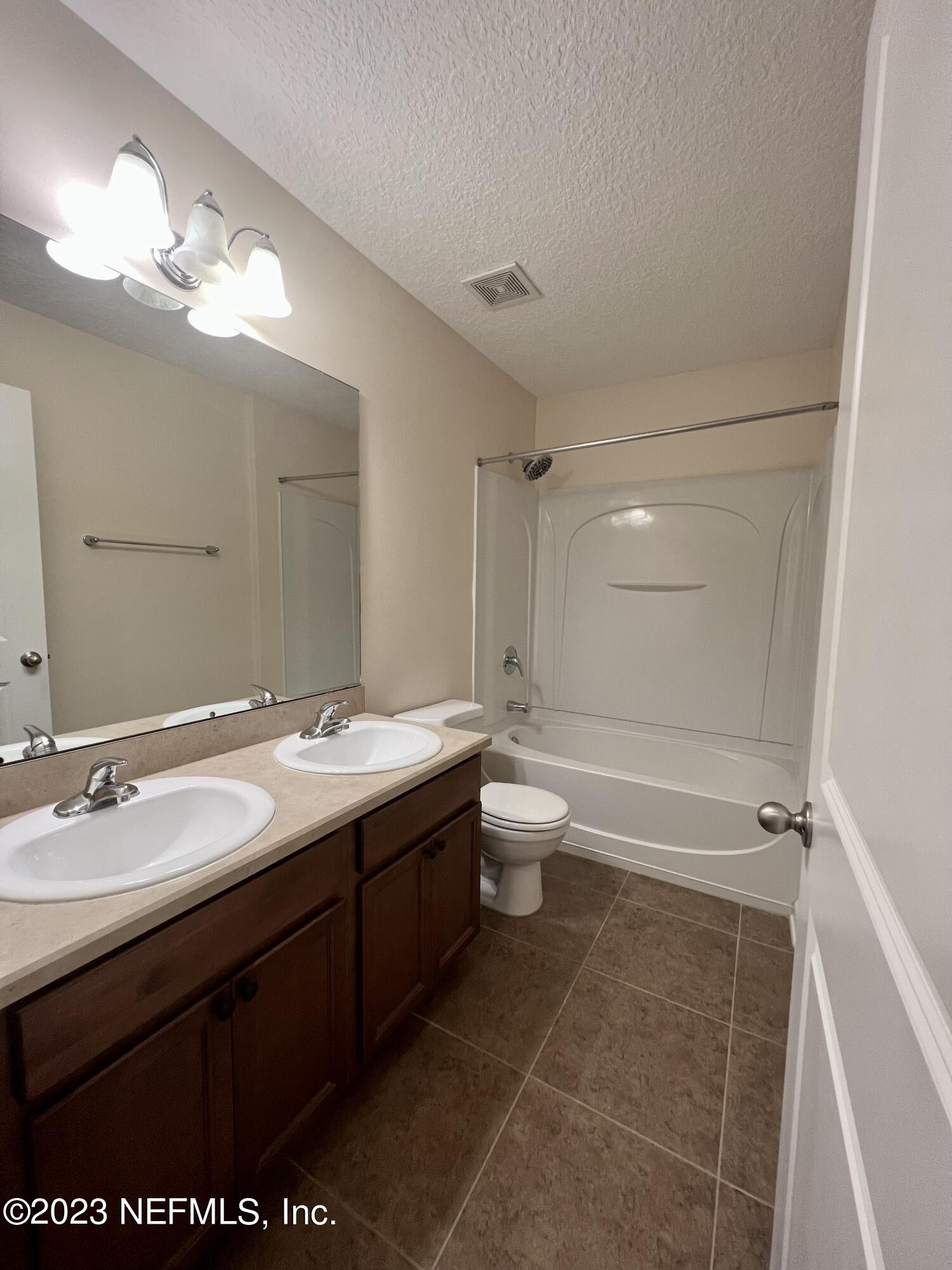 120 East Franchetta Lane St. Augustine, FL 32092 - Photo 17 of 25 a bathroom with a sink a toilet a mirror and shower