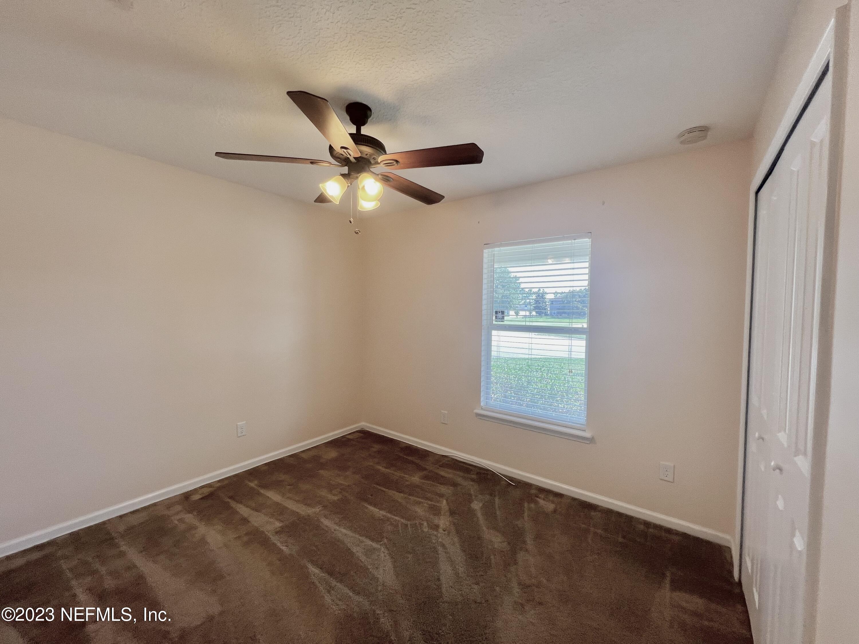 120 East Franchetta Lane St. Augustine, FL 32092 - Photo 19 of 25 an empty room with a window and a fan