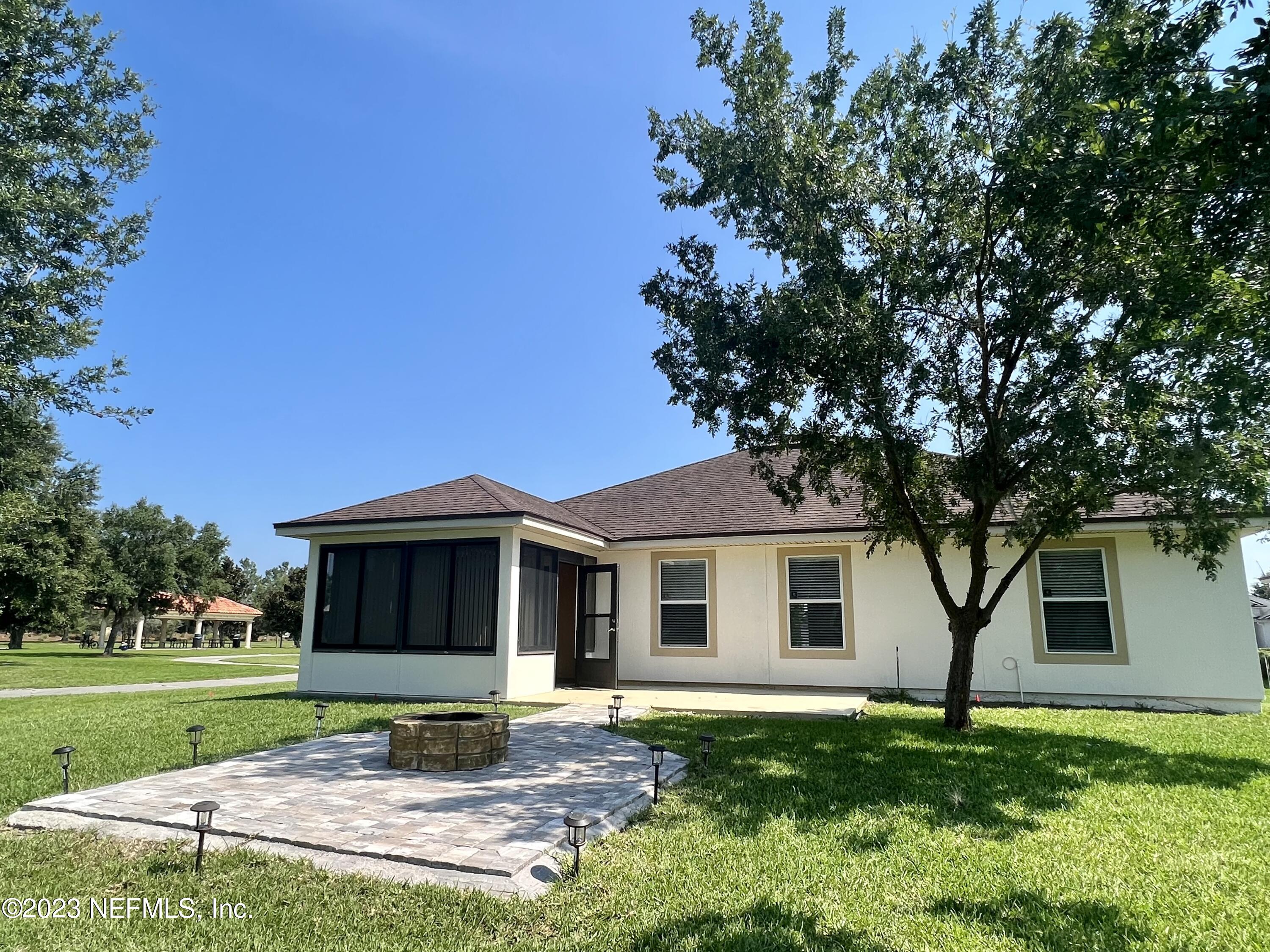 120 East Franchetta Lane St. Augustine, FL 32092 - Photo 21 of 25 a front view of a house with garden