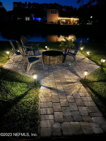 a view of a patio with table and chairs and potted plants