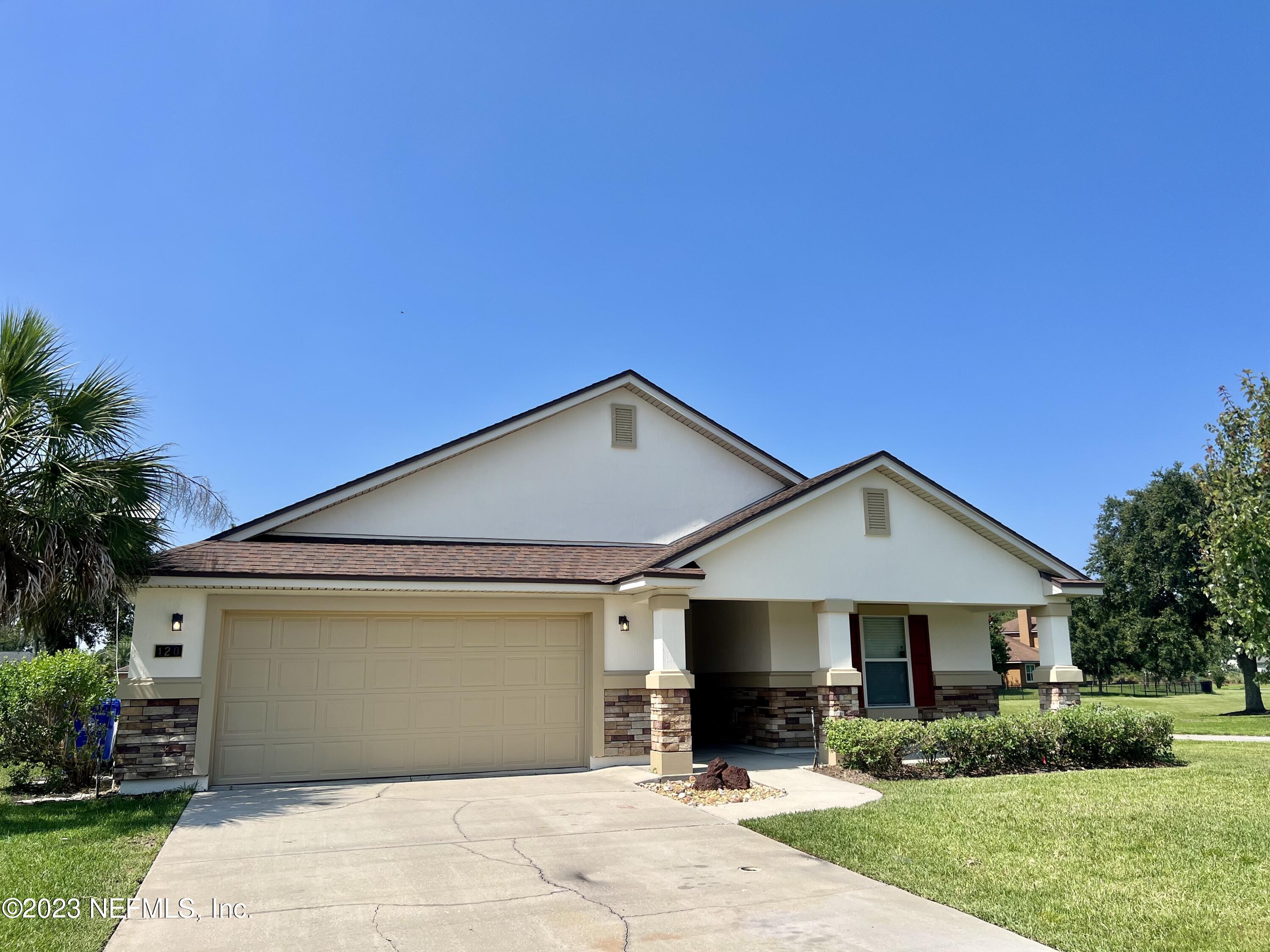 120 East Franchetta Lane St. Augustine, FL 32092 - Photo 24 of 25 a front view of a house with a yard and trees