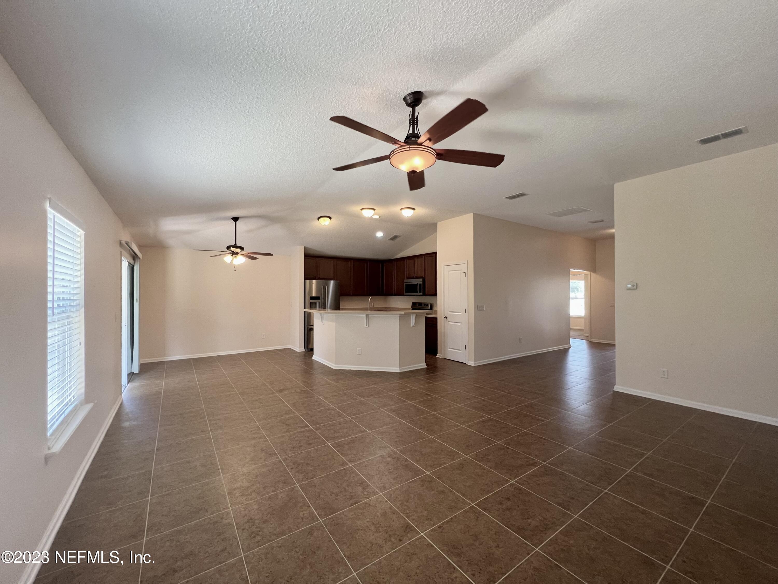 120 East Franchetta Lane St. Augustine, FL 32092 - Photo 9 of 25 a view of a livingroom with a ceiling fan and window