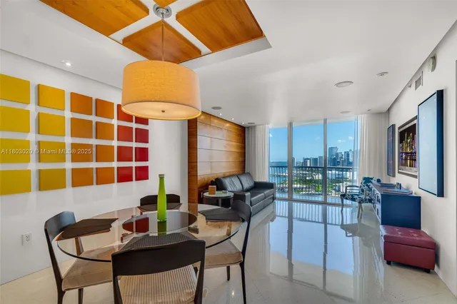 a view of a livingroom with furniture and a large window