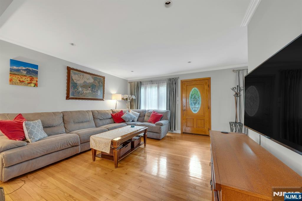 24 Cambridge Road Tenafly, NJ 07670 - Photo 7 of 31 a living room with furniture and a flat screen tv