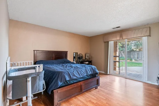 a bedroom with a bed and glass door