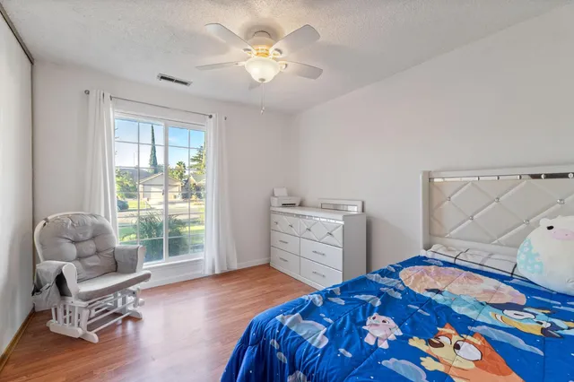 a bedroom with a bed and a chair