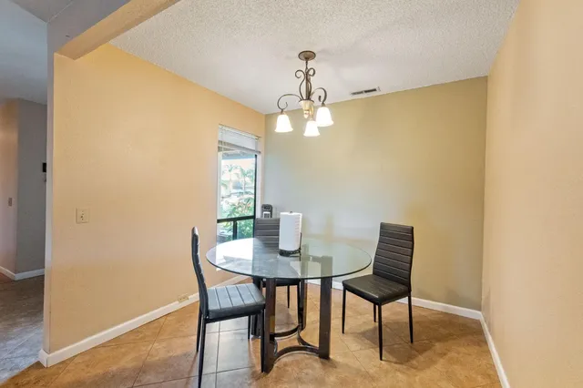 a view of a dining room with furniture and chandelier